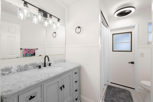 5647 SE Sailfish Way, Stuart, FL 34997 - bathroom with wainscoting, vanity, and a shower with curtain