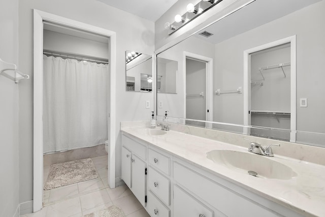 3733 Cape Pointe Cir, Jupiter, FL 33477 - full bath featuring double vanity, marble look tile flooring, curtained shower, and a walk in closet