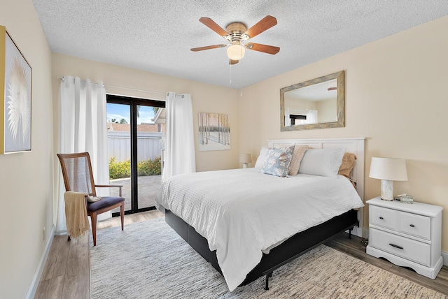 3733 Cape Pointe Cir, Jupiter, FL 33477 - bedroom featuring access to outside, light wood-style floors, a textured ceiling, and a ceiling fan