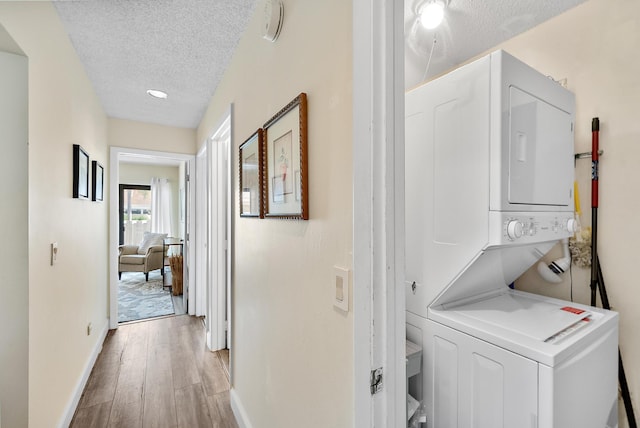 3733 Cape Pointe Cir, Jupiter, FL 33477 - laundry area with stacked washer / dryer, a textured ceiling, light wood finished floors, and recessed lighting