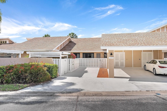 3733 Cape Pointe Cir, Jupiter, FL 33477 - townhome / multi-family property featuring a fenced front yard, a gate, roof with shingles, and stucco siding