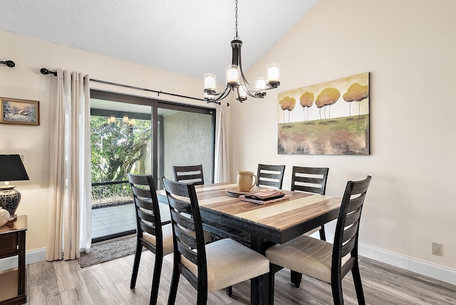 3733 Cape Pointe Cir, Jupiter, FL 33477 - dining room featuring a chandelier, light wood finished floors, and vaulted ceiling