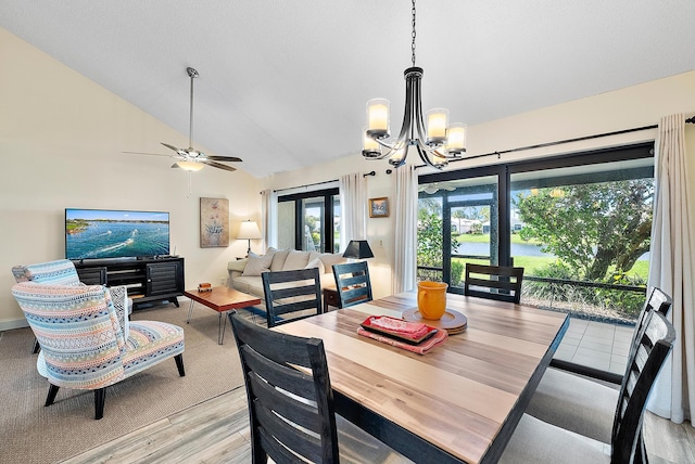 3733 Cape Pointe Cir, Jupiter, FL 33477 - dining room featuring a chandelier, ceiling fan, lofted ceiling, and light wood-style flooring