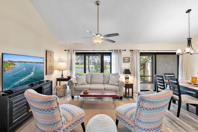 3733 Cape Pointe Cir, Jupiter, FL 33477 - living room with lofted ceiling, wood finished floors, a chandelier, a textured ceiling, and ceiling fan