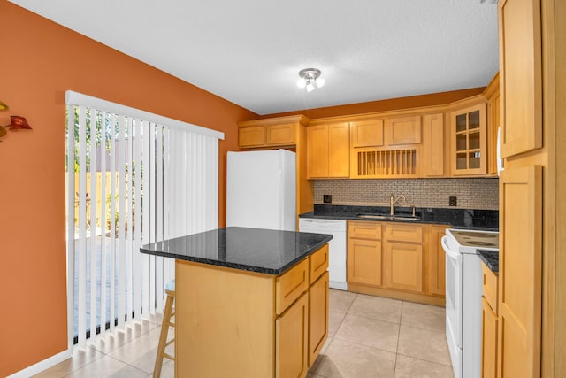 5693 SE Windsong Ln Unit 545, Stuart, FL 34997 - kitchen featuring white appliances, backsplash, a breakfast bar area, a center island, and light tile patterned floors