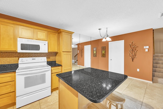 5693 SE Windsong Ln Unit 545, Stuart, FL 34997 - kitchen featuring white appliances, decorative backsplash, a kitchen island, a textured ceiling, and light tile patterned floors