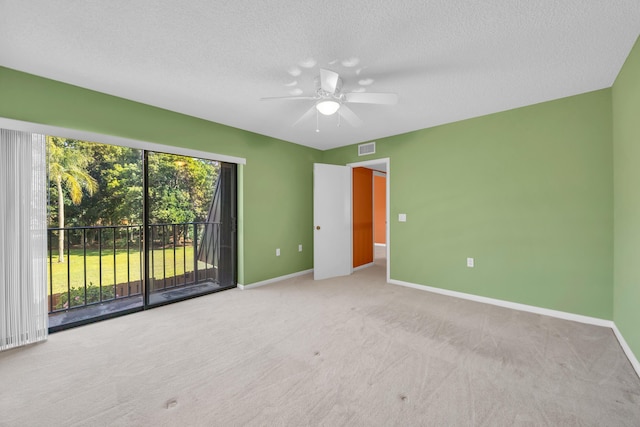 5693 SE Windsong Ln Unit 545, Stuart, FL 34997 - unfurnished bedroom featuring access to outside, a textured ceiling, carpet, and ceiling fan
