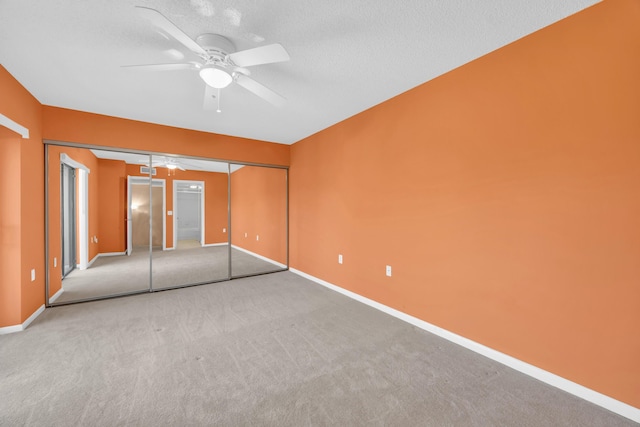 5693 SE Windsong Ln Unit 545, Stuart, FL 34997 - unfurnished bedroom with carpet flooring, a textured ceiling, a ceiling fan, and elevator