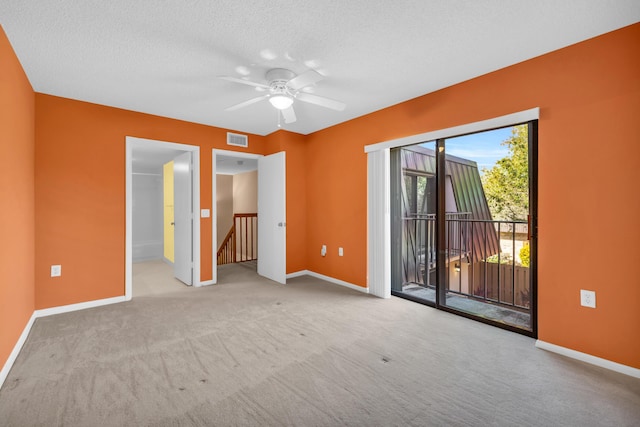 5693 SE Windsong Ln Unit 545, Stuart, FL 34997 - empty room featuring carpet floors, a ceiling fan, and a textured ceiling