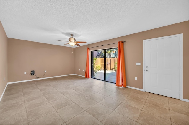 5693 SE Windsong Ln Unit 545, Stuart, FL 34997 - spare room with a ceiling fan, a textured ceiling, and light tile patterned floors