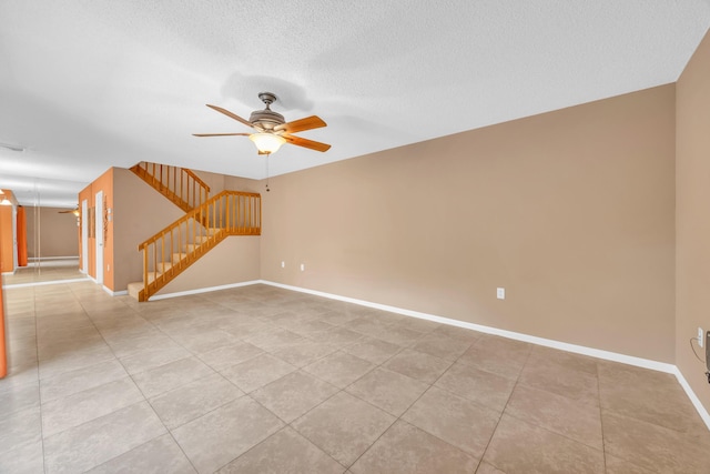 5693 SE Windsong Ln Unit 545, Stuart, FL 34997 - spare room featuring stairway, ceiling fan, light tile patterned flooring, and a textured ceiling