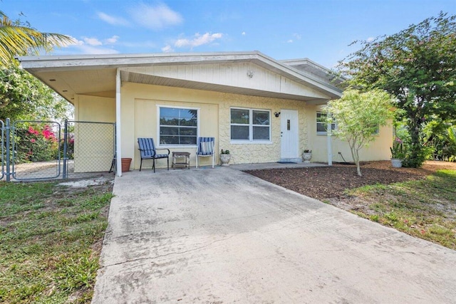 1625 SE Dixie Hwy, Stuart, FL 34994 - view of front of home featuring stone siding and a gate