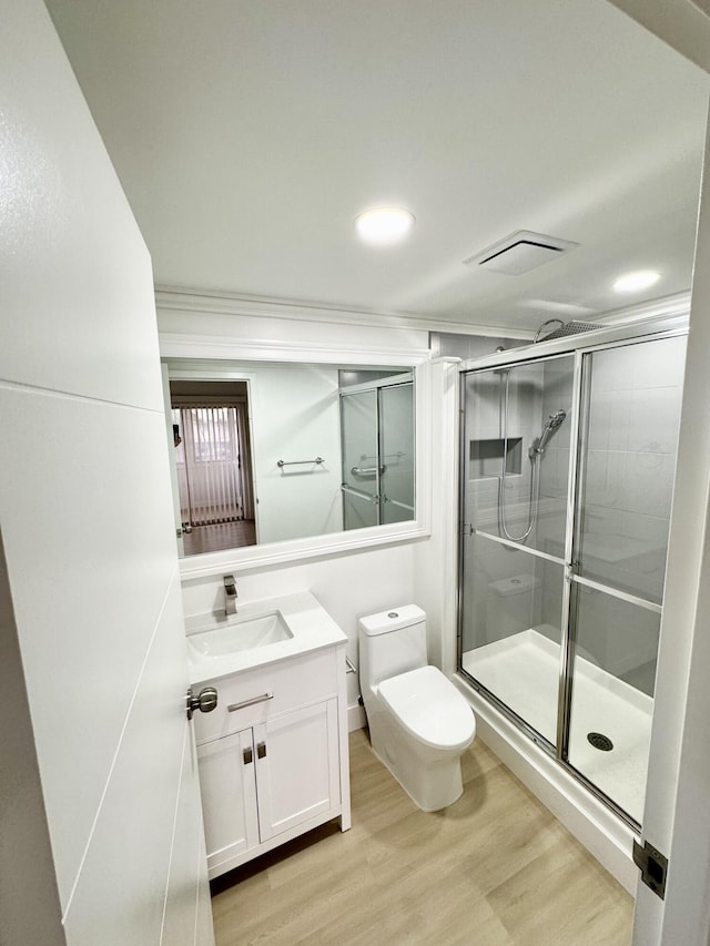 330 Saxony G 330, Delray Beach, FL 33446 - bathroom featuring vanity, crown molding, wood finished floors, a stall shower, and recessed lighting