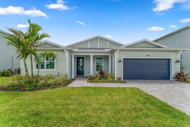 13566 SW Bally Dr, Port Saint Lucie, FL 34987 - ranch-style home featuring driveway, a garage, and a front yard