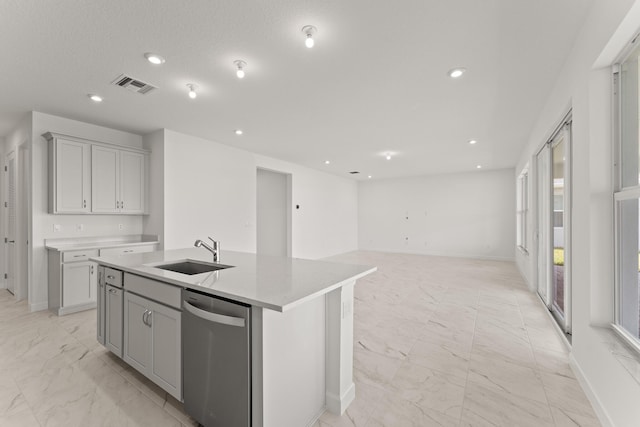 13566 SW Bally Dr, Port Saint Lucie, FL 34987 - kitchen featuring dishwasher, light marble finish floors, an island with sink, light countertops, and recessed lighting