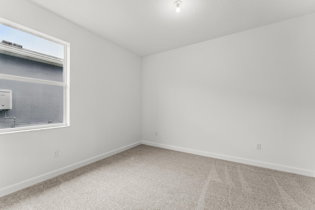 9555 SW Indra Way, Port Saint Lucie, FL 34987 - carpeted spare room featuring baseboards