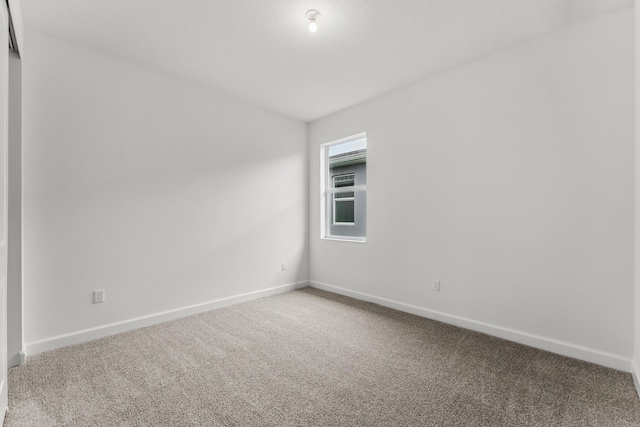 9555 SW Indra Way, Port Saint Lucie, FL 34987 - spare room featuring carpet and baseboards