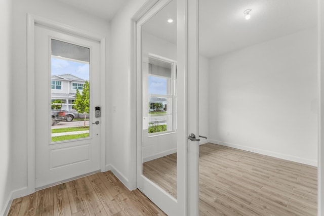 9555 SW Indra Way, Port Saint Lucie, FL 34987 - entryway featuring light wood finished floors and plenty of natural light