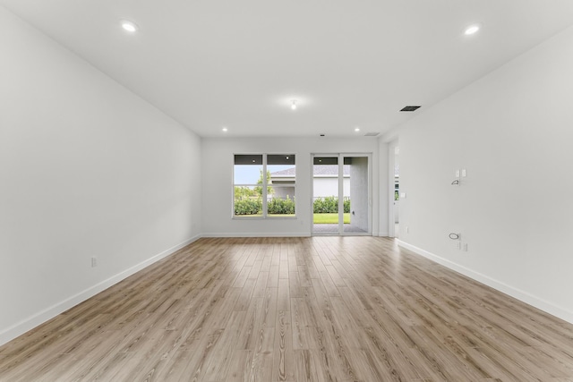 9555 SW Indra Way, Port Saint Lucie, FL 34987 - empty room featuring light wood finished floors and recessed lighting