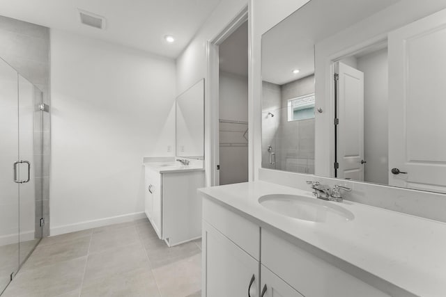9555 SW Indra Way, Port Saint Lucie, FL 34987 - full bath featuring a stall shower, two vanities, tile patterned flooring, a walk in closet, and recessed lighting