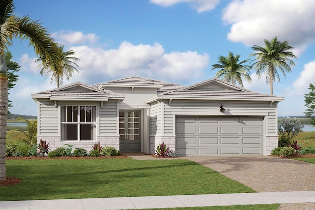 10088 SW Carnelian St, Port Saint Lucie, FL 34987 - view of front facade featuring decorative driveway, a garage, and a front yard