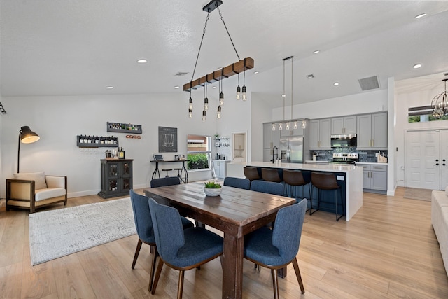 6572 Brookhurst Cir, Lake Worth, FL 33463 - dining area with light wood finished floors, recessed lighting, a chandelier, and high vaulted ceiling