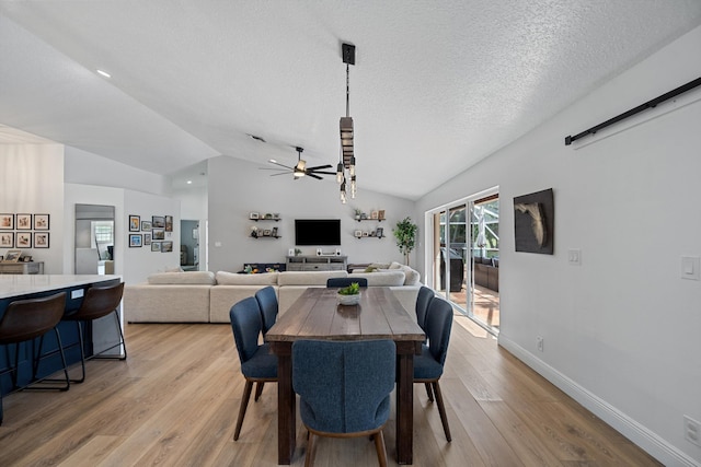 6572 Brookhurst Cir, Lake Worth, FL 33463 - dining space featuring vaulted ceiling, ceiling fan, light wood-style floors, and a textured ceiling