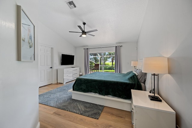 6572 Brookhurst Cir, Lake Worth, FL 33463 - bedroom with vaulted ceiling, access to exterior, light wood-type flooring, a textured ceiling, and a ceiling fan