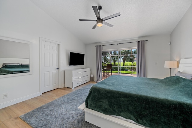 6572 Brookhurst Cir, Lake Worth, FL 33463 - bedroom featuring wood finished floors, access to outside, lofted ceiling, a ceiling fan, and a textured ceiling