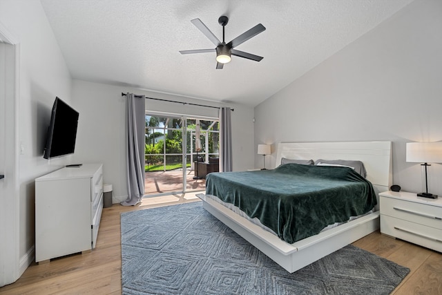 6572 Brookhurst Cir, Lake Worth, FL 33463 - bedroom with access to exterior, a textured ceiling, lofted ceiling, light wood finished floors, and ceiling fan