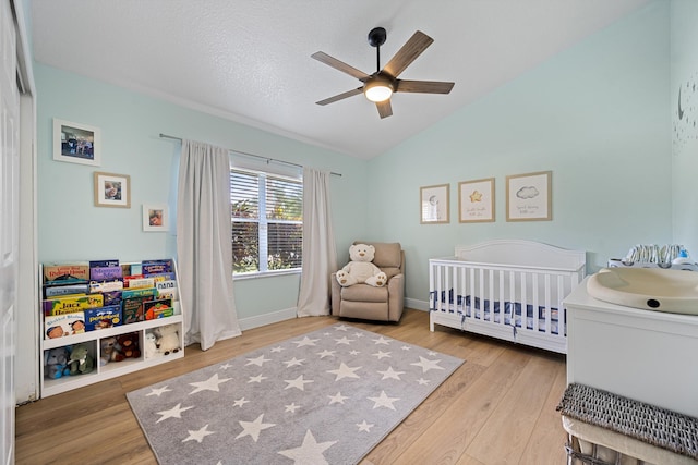 6572 Brookhurst Cir, Lake Worth, FL 33463 - bedroom with a crib, wood finished floors, vaulted ceiling, and a ceiling fan