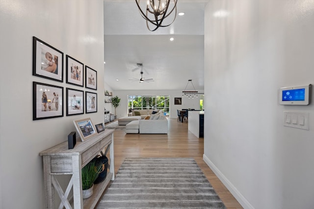 6572 Brookhurst Cir, Lake Worth, FL 33463 - hall with wood finished floors, a chandelier, and recessed lighting