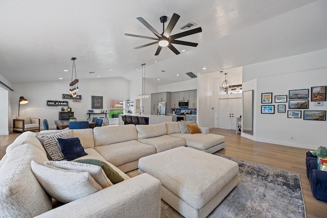 6572 Brookhurst Cir, Lake Worth, FL 33463 - living area featuring a chandelier, light wood finished floors, vaulted ceiling, a ceiling fan, and recessed lighting