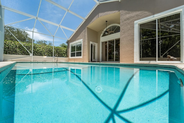 3002 SE Brierwood Pl, Stuart, FL 34997 - outdoor pool with a ceiling fan and glass enclosure