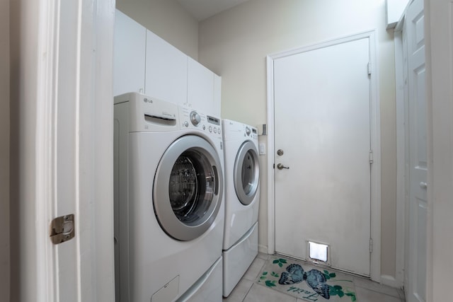 3002 SE Brierwood Pl, Stuart, FL 34997 - laundry area featuring washer and dryer, light tile patterned floors, and cabinet space