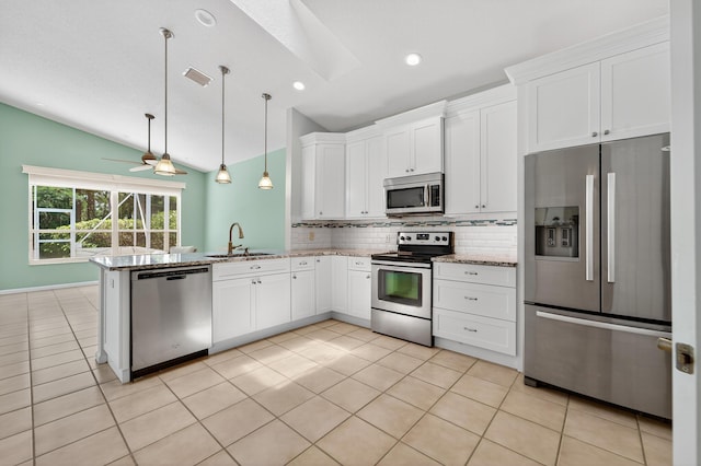 3002 SE Brierwood Pl, Stuart, FL 34997 - kitchen featuring stainless steel appliances, lofted ceiling, tasteful backsplash, white cabinetry, and light stone countertops