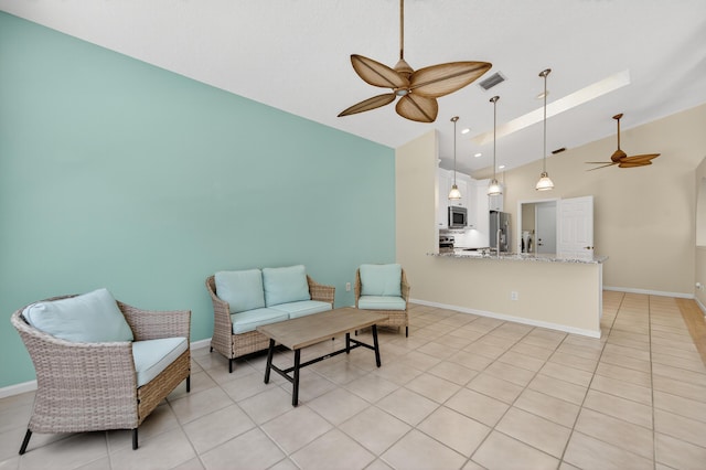 3002 SE Brierwood Pl, Stuart, FL 34997 - living area featuring ceiling fan, light tile patterned floors, high vaulted ceiling, and a skylight