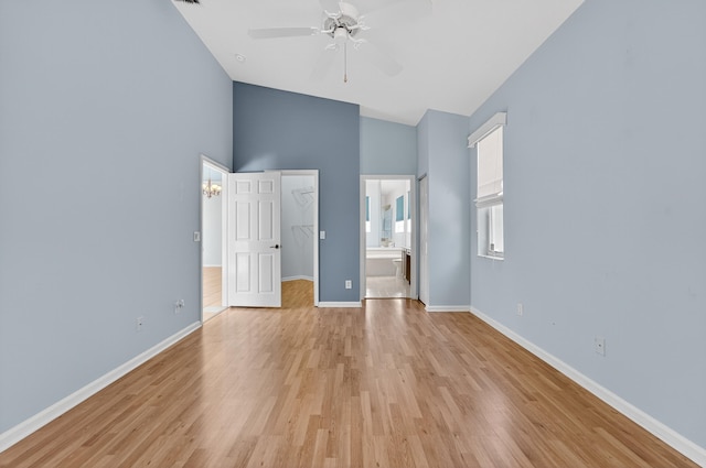 3002 SE Brierwood Pl, Stuart, FL 34997 - unfurnished bedroom with a walk in closet, high vaulted ceiling, light wood-type flooring, ensuite bathroom, and a closet