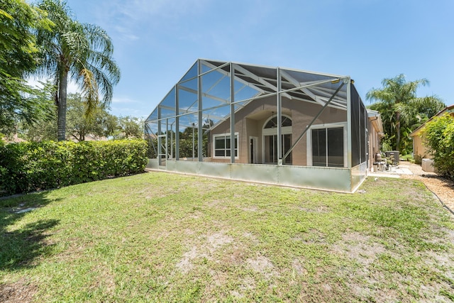3002 SE Brierwood Pl, Stuart, FL 34997 - rear view of property with a yard, glass enclosure, and a patio