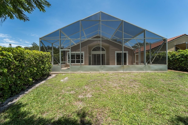 3002 SE Brierwood Pl, Stuart, FL 34997 - rear view of house featuring glass enclosure, a yard, and stucco siding
