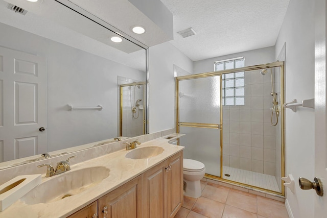 163 Pepper Ln, Jensen Beach, FL 34957 - bathroom featuring a shower stall, double vanity, tile patterned flooring, and a textured ceiling