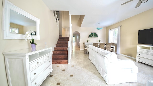 126 Hidden Hollow Dr, Palm Beach Gardens, FL 33418 - living area with stairs, ceiling fan, arched walkways, and light tile patterned flooring