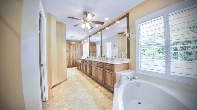 126 Hidden Hollow Dr, Palm Beach Gardens, FL 33418 - full bath with healthy amount of natural light, double vanity, a ceiling fan, a garden tub, and recessed lighting