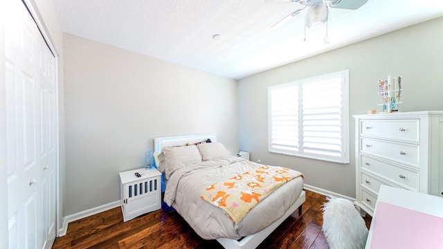 126 Hidden Hollow Dr, Palm Beach Gardens, FL 33418 - bedroom featuring a closet, dark wood-style flooring, and a ceiling fan