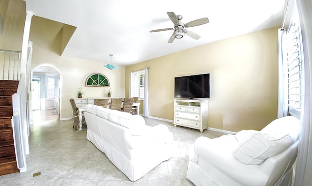 126 Hidden Hollow Dr, Palm Beach Gardens, FL 33418 - living room with a ceiling fan, healthy amount of natural light, arched walkways, and light tile patterned floors