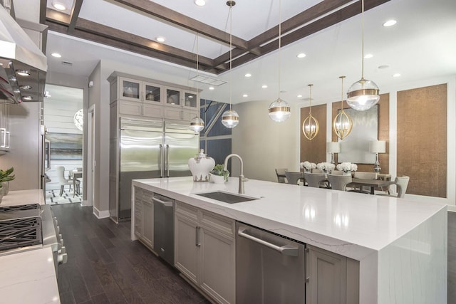 13405 Artisan Cir, Palm Beach Gardens, FL 33418 - kitchen featuring appliances with stainless steel finishes, extractor fan, light stone counters, dark wood finished floors, and coffered ceiling