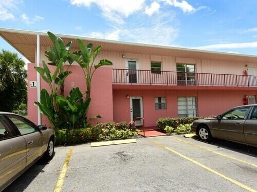 2 Golfs Edge Unit F, West Palm Beach, FL 33417 - view of building exterior featuring uncovered parking
