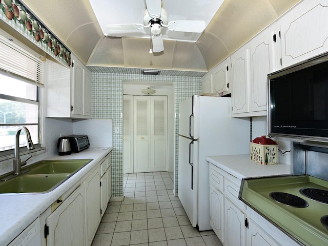 2 Golfs Edge Unit F, West Palm Beach, FL 33417 - kitchen featuring white appliances, white cabinets, light tile patterned floors, light countertops, and ceiling fan
