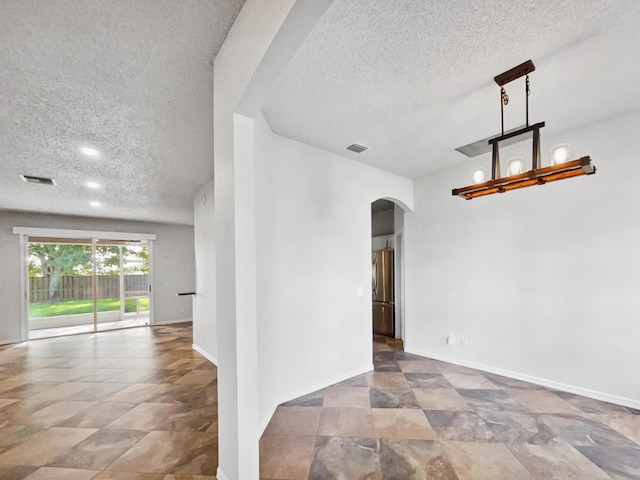 2081 SW Burlington St, Port Saint Lucie, FL 34984 - unfurnished room with arched walkways and a textured ceiling