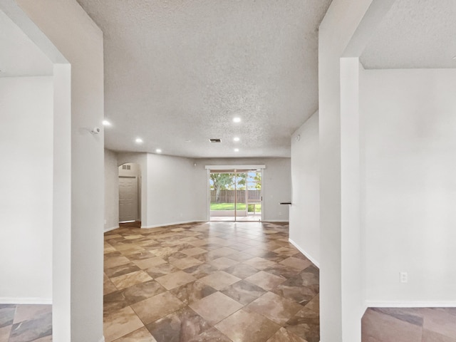 2081 SW Burlington St, Port Saint Lucie, FL 34984 - empty room with a textured ceiling, recessed lighting, and arched walkways